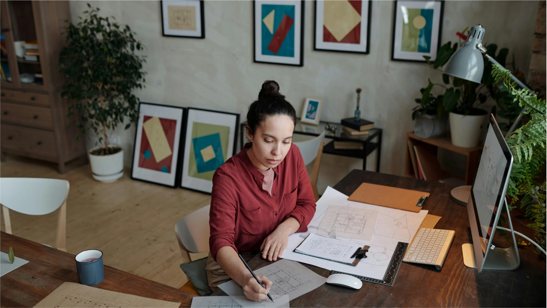 Photo of a woman sitting at a desk working on documents.